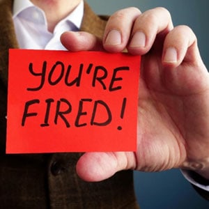 A man holds up a paper with the words You're fired - Law Offices of David A. Kaufman, APC.